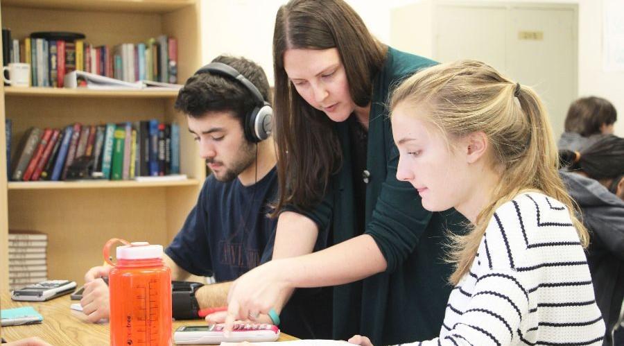 Math teacher Leah Higginbotham works with students during ReFLECT.