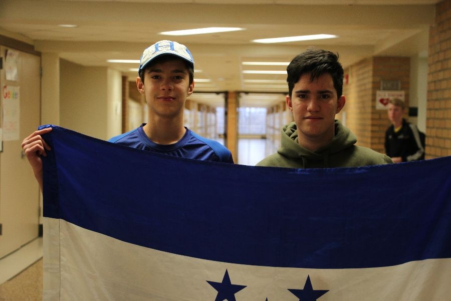 Andrés and Ramon pose with the flag of their home country