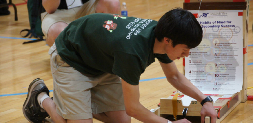 William Newhouse, 12, adjusts his Scrambler vehicle before a Science Olympiad competition.