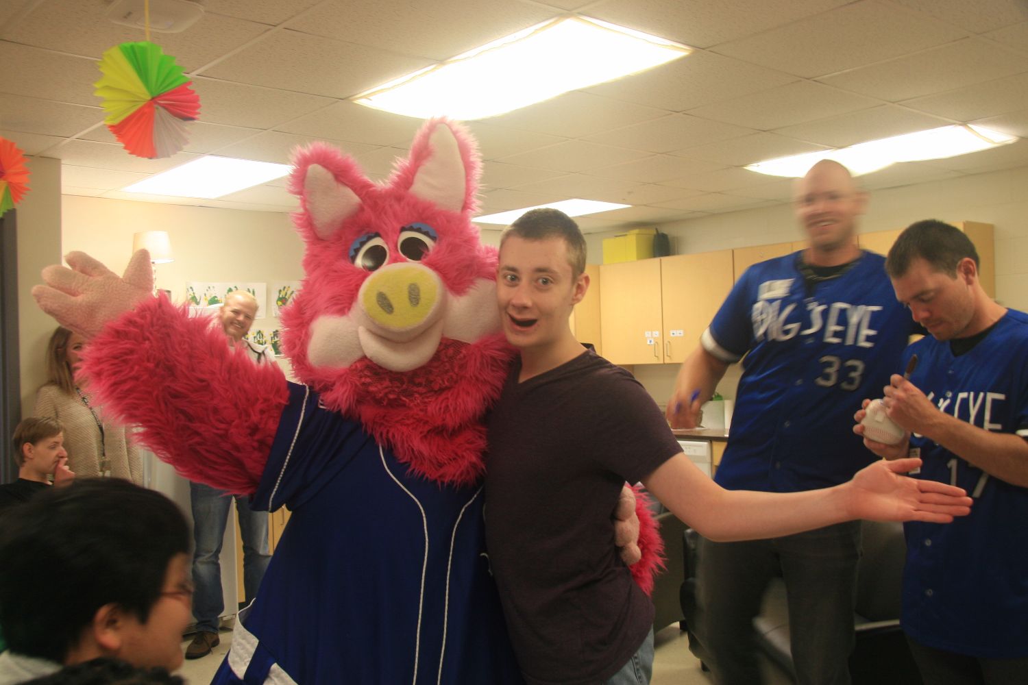 Saints players and mascot visit special education class.