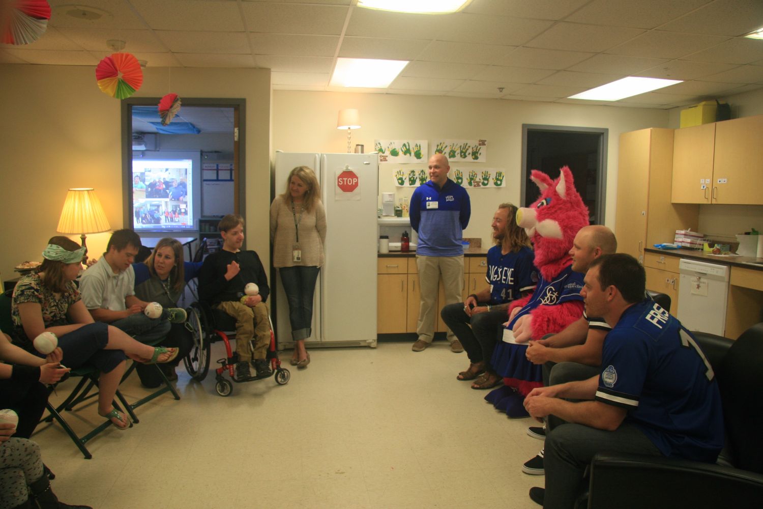 Saints players and mascot visit special education class.
