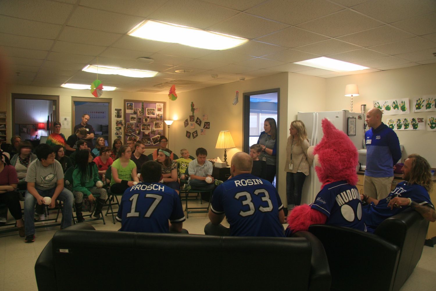 Saints players and mascot visit special education class.