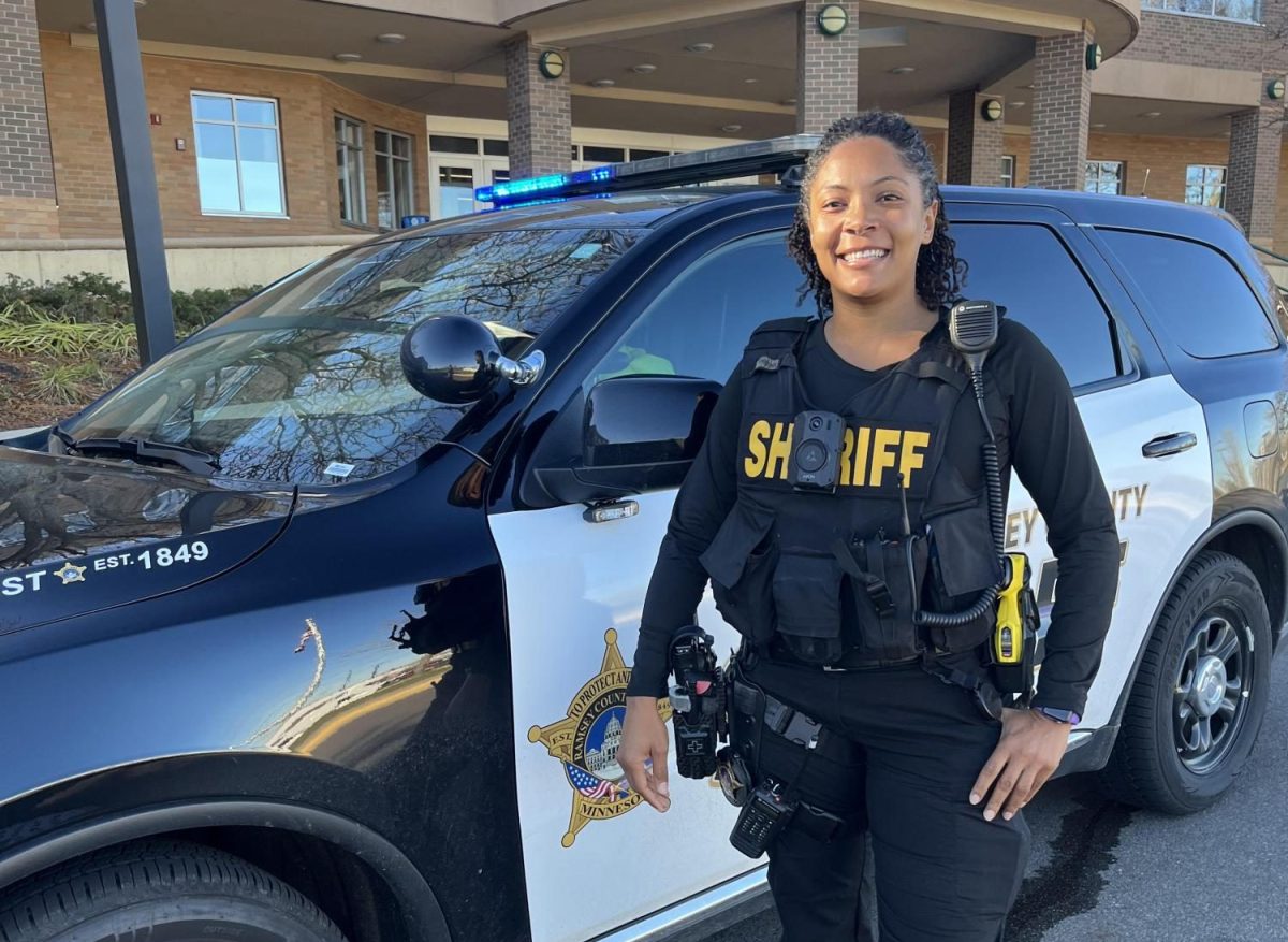 Giles poses in front of her squad car.