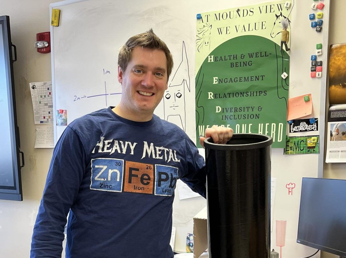 Jacob Hairrell poses with one of his telescopes. 