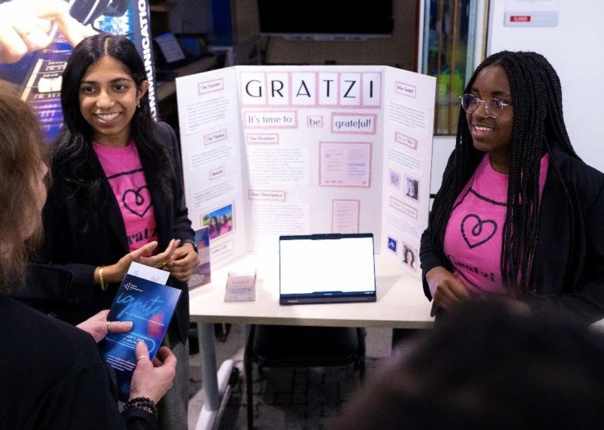 Subramanian+and+Sackih+showcase+their+app+Junior+Achievement+Pitchfest.