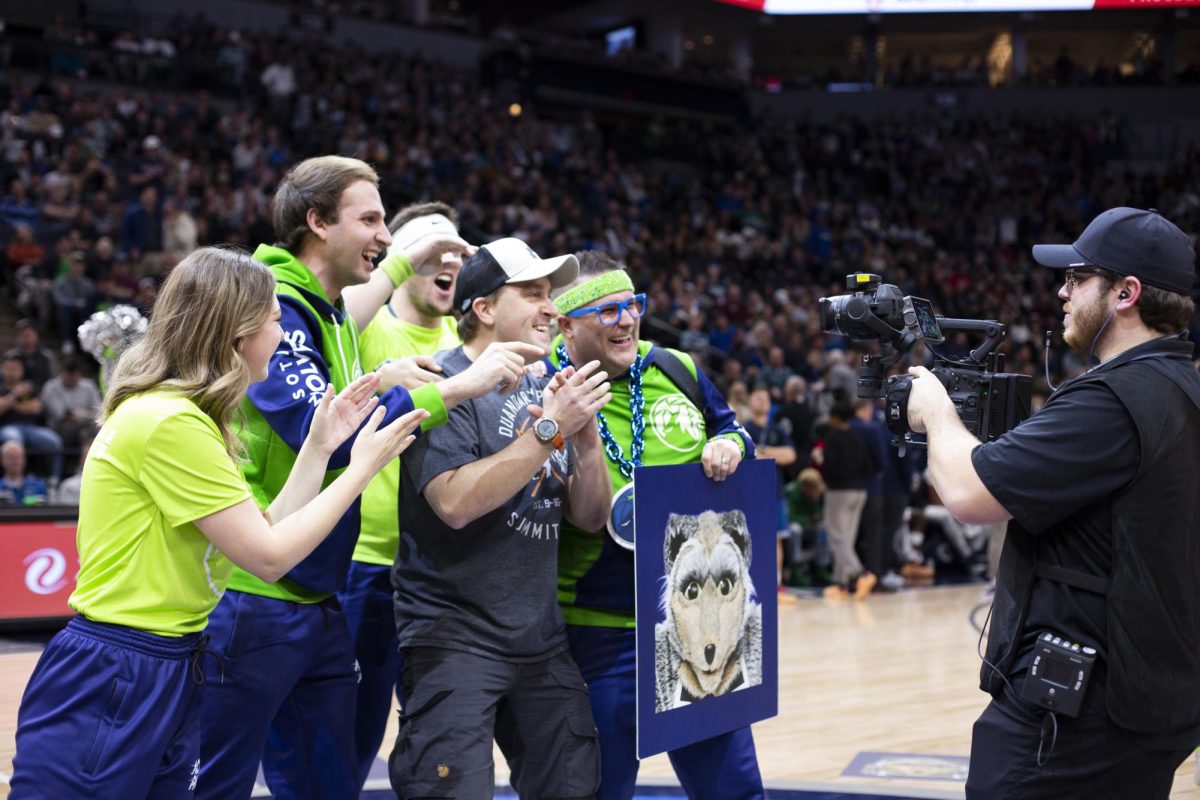 The Action Pack hypes up the crowd and gets photos with fans at the NBA game.