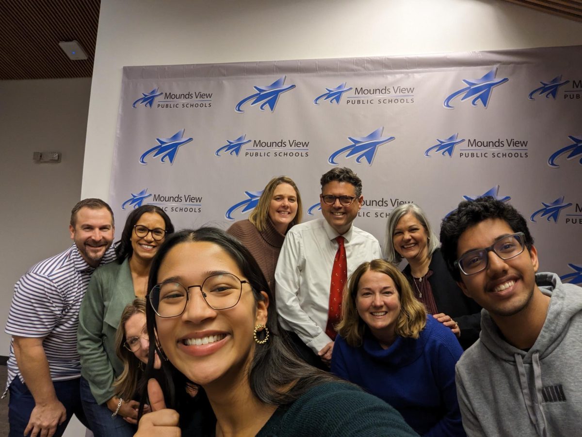 Mounds View High School seniors Hridaya Ghosh and Pratham Snehi pose for a selfie with Mounds View School Board members.