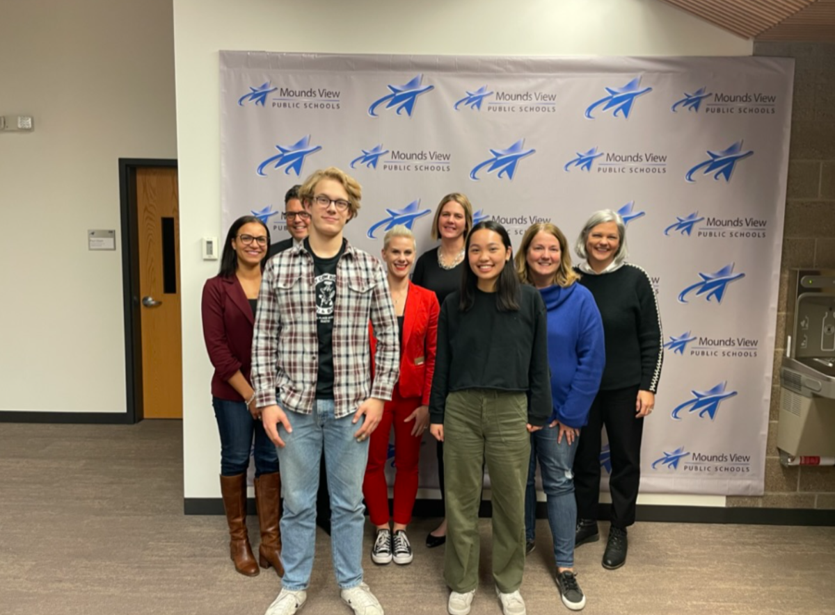 Ben Refsell and Allison Yu (front) with the Mounds View School Board (back) after advocating for a Food to Hog program at Mounds View High School.