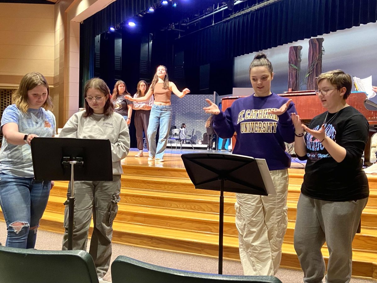 INTERPRETING. Senior Haley Schwendemann, junior Whitney O’Connell, senior Brooklyn Both and
senior Alice Jerome at theater rehearsal practicing for the ASL interpretation of Cinderella.