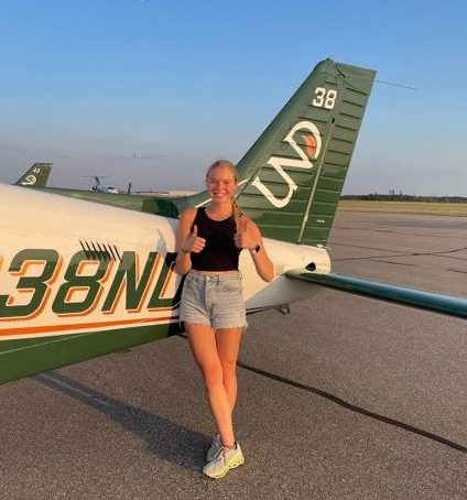 Sabby pictured with the Piper Archer she flies.