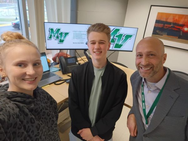 Seniors Chloe Tilstra (left) and Oliver Boswell (middle) produce the Daily HERD in the office of Principal Rob Reetz (right).